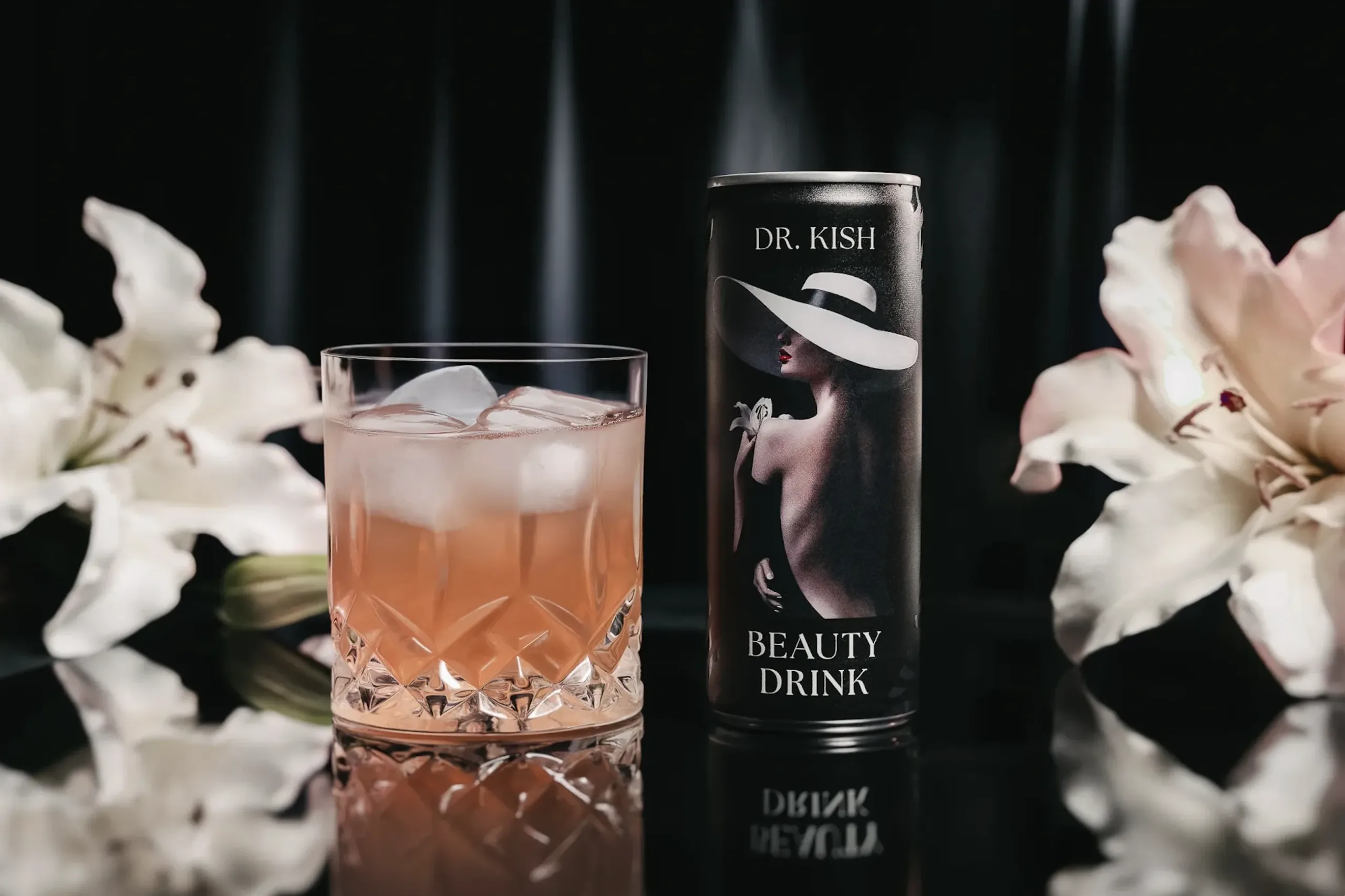 Dr. Kish Beauty Drink in elegant glass with ice, surrounded by white lilies, emphasizing aesthetic appeal and anti-aging benefits.